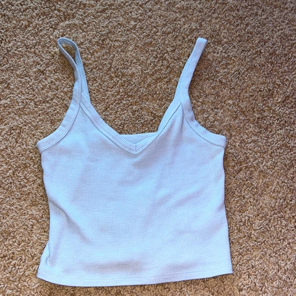 Cropped. Light material. Never worn except trying on. A little loose.